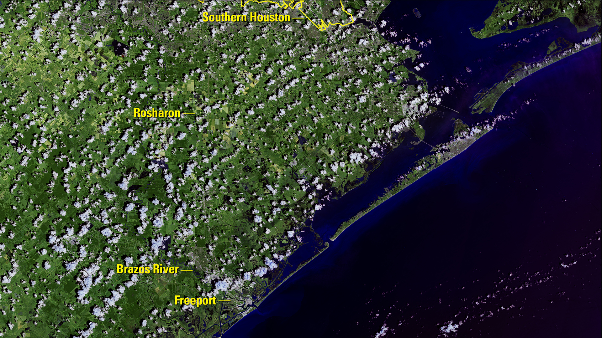 USGS Landsat 8 view labeled August 12, 2017, showing the Brazos River corridor near Rosharon and Freeport before Hurricane Harvey, with green land and scattered clouds.